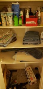 lot 151 image: Contents of 3 Shelves Bathroom Rugs, towels, Shampoos and lotions and more