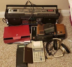 lot 156 image: Panasonic Cassette Tape Player and Radio RX-FM40, Radio Shack Clock Radio, Radio Shack Electronic Organizer, Sony Digital Book Reader, Maxell HP-550 gold headphones with mic