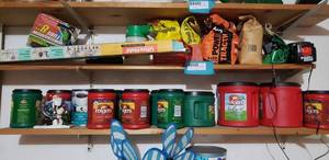 lot 217 image: Contents on Shelves Black&Decker Battery Charger, Ultra-Hold Yard Tool Organizer, Wheelbarrow Tube 8, Miracle Gro Hose Sprayer
