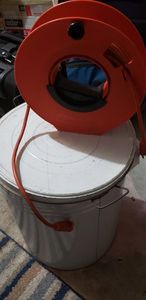 lot 216 image: Manual Extension Cord Storage Reel and Tin with Rags