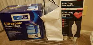 lot 91 image: ReliOn Humidifier Model H-0565-0, CVS Extra Long Heating Pad, and Set of Sock Sliders