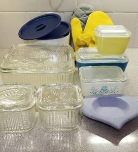 lot 56 image: Hot Mitts, Rubber Cleaning Gloves, Bundt Cake Pan, and Pyrex Refrigerator Dishes with Lids