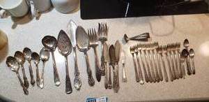lot 58 image: Silver Plated Serving Spoons and Forks and Butter Knives, Last Cream Top Spoon has dates 1924 and 1925 on the handle