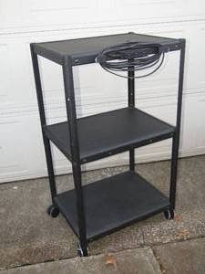 lot 102 image: Metal media 3-shelf utility cart, With attached power strip on casters