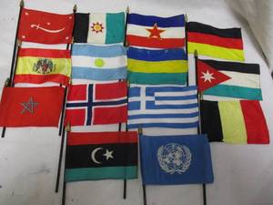 lot 60 image: Basket of Mixed Small Desk Top Flags, Their are about 8-flags of each shown,