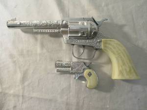 lot 100 image: 2-Vintage Cap Guns, 1-Pony Boy Toy Cap Gun Pistol And 1-Leslie Henry Ivory Grip Derringer Toy Cap Gun, Single Cap Shooter