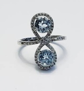 lot 10 image: Sterling Silver Ring with 2 Topaz Stones.  Stamped 925 - Size 6.5