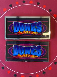 lot 126 image: 2 Dunes Slot Machine Glass 1 is in a frame