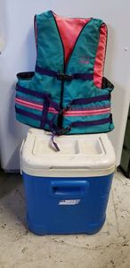 lot 8 image: Igloo Cooler with Drink Spout and Cup Holders on top and Stearns Life Vest