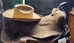 lot 64 image: Leather Saddle and Straw Hat