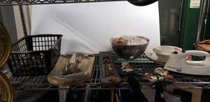 lot 71 image: Vintage Stainless Carving Set and Fish Cutting Board, Silver Plate Serving Utensils, Ceramic Chef on Motorcycles Towels Hangers, Plastic Apples and Black&Decker Steam Iron