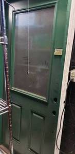 lot 74 image: Half Glass Exterior Door, Green with Frame 36x80 approx.