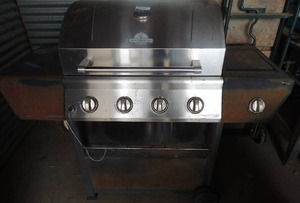 lot 1 image: Grill master Grill propane, wheels, a little rusty 52x23x47 tall