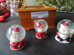lot 112 image: Mr. Christmas Cannon ball express music box  works and 3 Santa snow globes