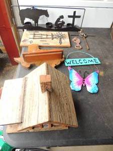 lot 127 image: Western decor including small log cabin,  METAL HORSE RIDER & CROSS Tea light holder, Texas mantel shelf  , WINDMILL DECOR,  horse bottle opener, CROSS
