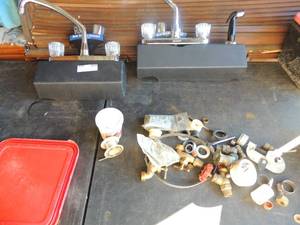 lot 260 image: 2 bathroom faucets both Glacier Bay black with silver  one has sprayer plus box of various kitchen  plumbing  items