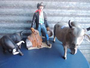 lot 314 image: 2 Bull statues (one is chipped) cowboy statue (some light chipping) no markings