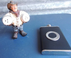 lot 321 image: Cowboy holding S&P shakers plus black and silver flask