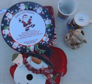 lot 326 image: Christmas mugs by Signature Housewares x 2, snowman birdhouse, snowman tea light holder Red snowflake  plates x 2 marked Lucerne foods, christmas serving platters