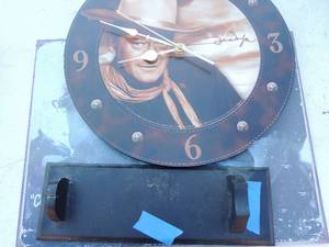 lot 330 image: Metal John Wayne sign 16x12 John wayne clock 13 with wooden stand