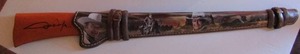 lot 24 image: JOHN WAYNE  LEGENDS OF THE WEST   DECPRATIVE WALL PLAQUE - RIFLE IN SLEEVE W IMAGES OF JOHN WAYNE   36 L BRADFORD EXVHANGE  #A-6088