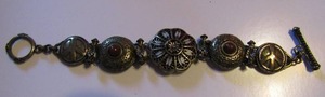 lot 336 image: 8 BRACELET  BRONZE COLOR W DESIGNS ON FRONT, BACK HAS FLORAL, LEAVES & BIRD