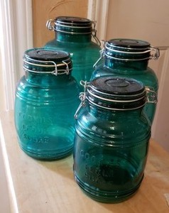 lot 31 image: Green Glass Wire Locking Lid Cannister Set