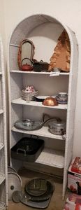 lot 203 image: Wicker Storage Shelf Unit and Contents as shown Includes Watermelon Dish, Punch Cups Cast Iron Boot and Tea Kettle