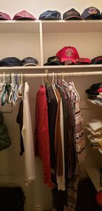 lot 144 image: Contents of Closet includes baseball Caps, Sleeping Bag, Shoe Polish