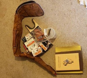 lot 154 image: Bird Hunters Lot RifleShotgun Soft Case, 12 Gauge Ammo, Gun Holster, National Championship 100th Running Souvenir Plate and More