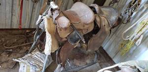 lot 437 image: 2 Saddles (One with No Horn) and Saddle Blankets and Stand as shown