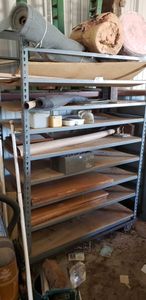 lot 408 image: Rolling Metal Shelf and Contents, includes pictures, large roll of metal screen. and insulation and more.