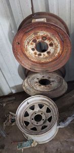 lot 370 image: 2 Hanging Rims welded for wire or hose storage, 1 5-lug 15 Rim