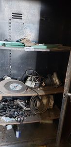 lot 372 image: Contents of Cabinet Only Includes Socket Wrench Sets, Cut off Blades, Circular Skil Saw, Drill with Metal Case, Electrical Wire and Clamps