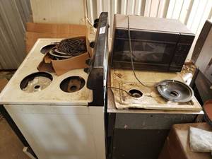 lot 405 image: Magic Chef Super Capacity Electric Stove Oven, Magic Chef Microwave, and Additional Stove Oven as shown