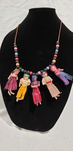 lot 757 image: Leather necklace with cloth mini village figures, wooden beads. Circa 1970-early 1980s.22L