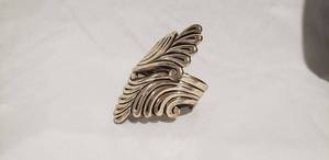 lot 766 image: Sterling silver vintage Bell Trading Post hinged cuff bracelet with scroll design. Marked with Bell arrow sign post with bell hanging  from it and sterling.