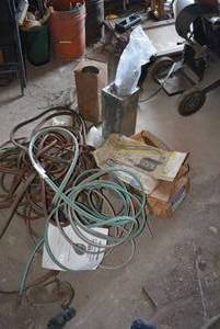lot 533 image: Torch lines for acetalene torches and large amount of welding rods.