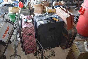lot 499 image: Large lot of luggage, vintage briefcase, shopping cart, and luggage cart