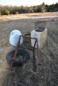 lot 688 image: Misc. Scrap Rabbit Cage, Blue Bin, Tire, Adjustable Metal Stand, File Cabinet