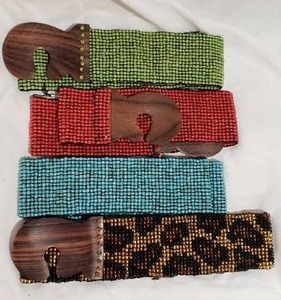 lot 789 image: Beaded Snake Skin Design and Red, Green and Blue Solid Color Elastic Belts (One with tag marked About Color, made in Indonesia)