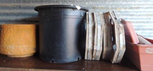 lot 12 image: 5 wooden hexagon planters STANDS, . 3 plastic planters long rectangle with tray and 2 large plastic planters brown and black