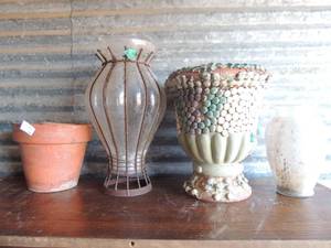 lot 11 image: 9 planters - 6 are terra cotta,  one is glass with metal design  one large terra cotta with gem inlay  and painted flowers