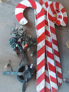 lot 13 image: Christmas tree stand, 2 strings of lights   4 large yard candy canes 53 tall