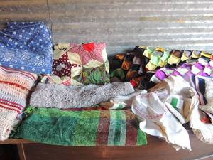 lot 263 image: Large lot of quilts. Rugs,  doilies and misc. fabric