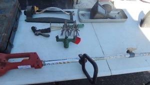 lot 264 image: Sprinkler, hose handle, Homelite weed eater (unknown working condition), light garden tiller, tool box with assorted bolts etc.