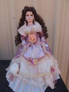 lot 93 image: 22 brunette porcelain doll with brown eyes