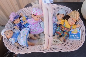 lot 102 image: My pals Gigo porcelain dolls x 5 in wicker basket