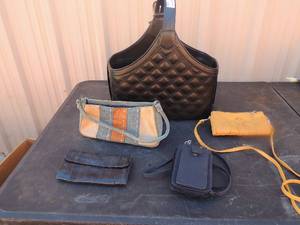 lot 103 image: Black bag full  of small bags and wallets