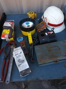lot 145 image: Propane  Tips, oil filter wrenches, knife sharpener, 12 volt flood light sanding belts 3  18 hardhat Ryobi 144V charger